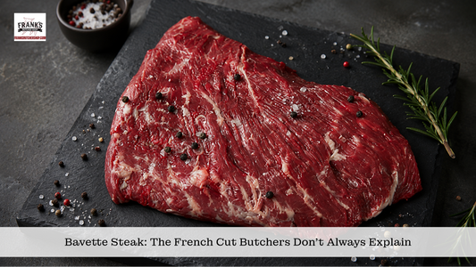 Raw bavette flap steak showing its loose grain on slate with rosemary and peppercorns.