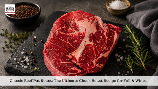 Raw boneless beef chuck roast on a dark slate board with rosemary, thyme, peppercorns, and coarse salt